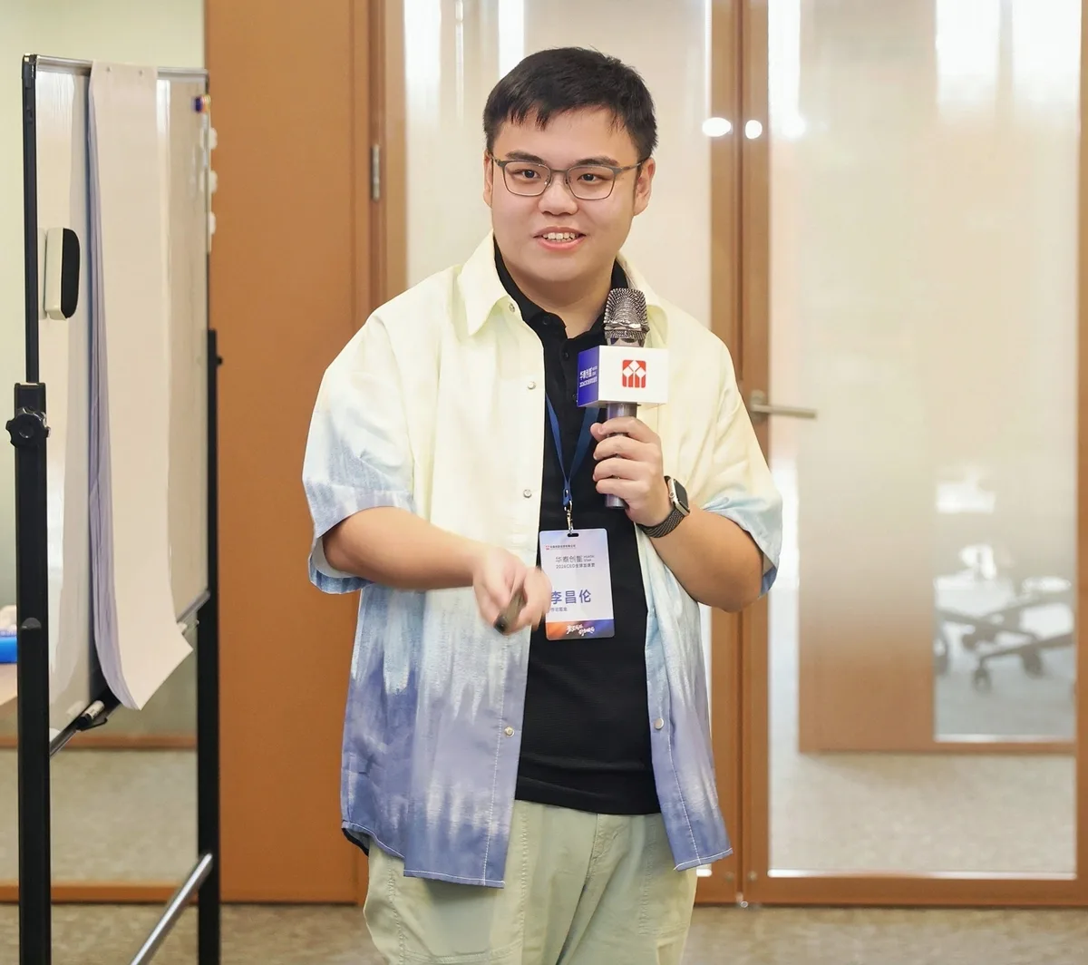 Speaking at a workshop beside a whiteboard